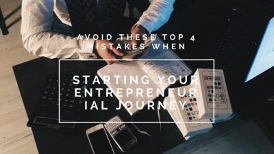 Someone sitting at a desk counting money and with a bunch of papers and phones, image used for lisa laporte post about avoiding entrepreneurial mistakes